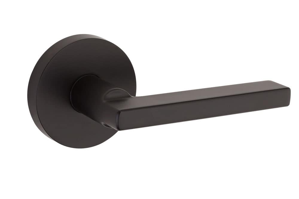 A black door handle with a modern, sleek design, attached to a circular base.