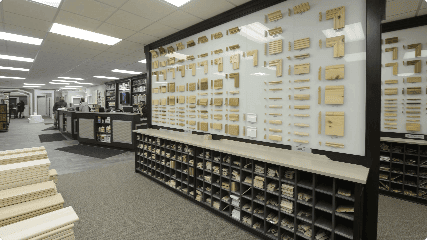 A neatly organized carpentry store displays a variety of wooden samples and tools on shelves and racks.