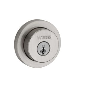 Close-up of a silver round door lock with the brand name Weiser engraved above the keyhole.
